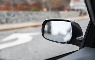 reflection in car mirror, conveying introspection and perspective in a fleeting moment of travel