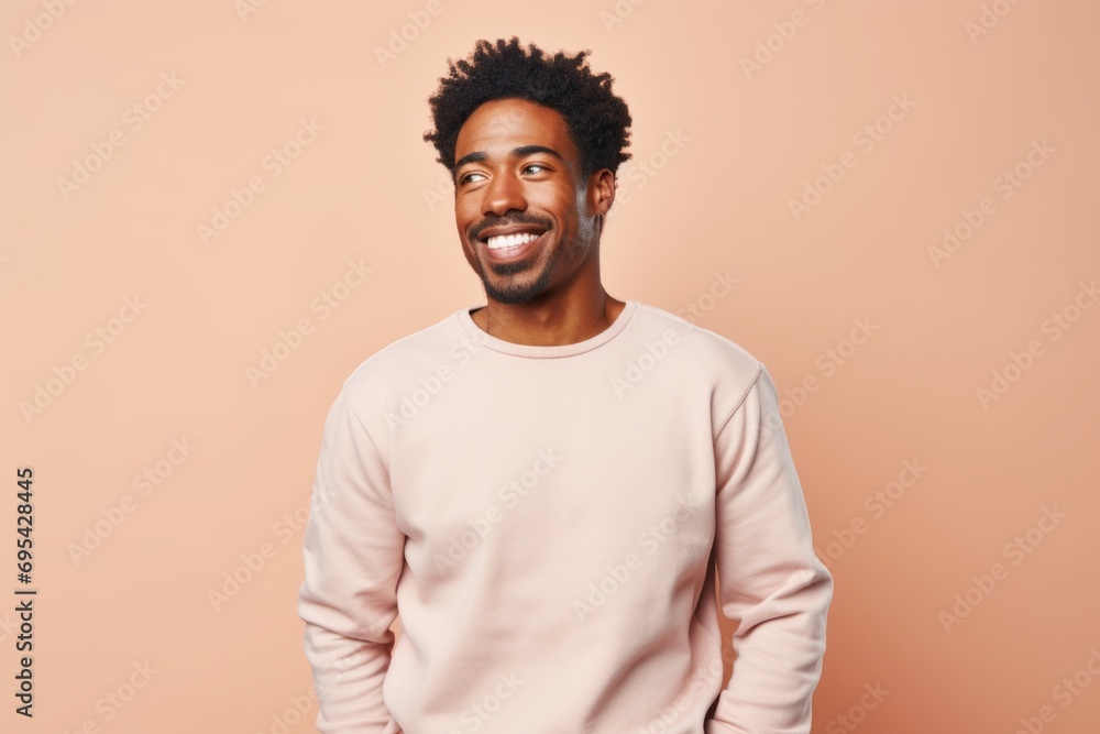 Wall mural Portrait of a merry afro-american man in his 30s dressed in a comfy fleece pullover against a pastel or soft colors background. AI Generation