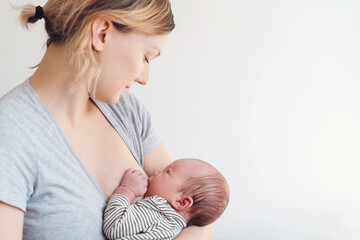 Mother breastfeeding baby. Baby eating mother's milk. - obrazy, fototapety, plakaty