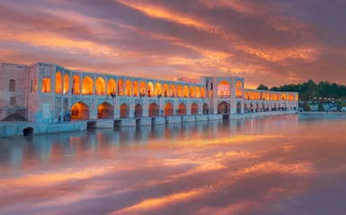 Papier Peint photo Pont Khadjou People resting in the ancient Khaju Bridge at amazing sunset - Isfahan, Iran  