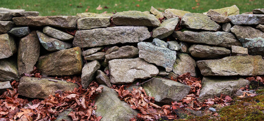 textured stone wall, showcasing rugged surface and natural patterns