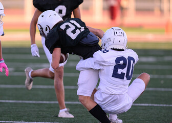 Athletic young football players making amazing plays running with, catching, kicking and throwing the ball during competitive games