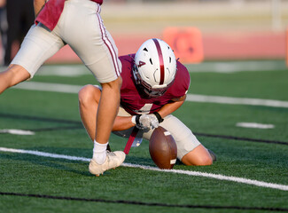 Athletic young football players making amazing plays running with, catching, kicking and throwing...