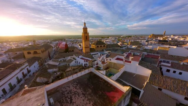FPV Drone flying at sunset over the church tower in Osuna