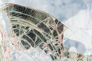 Close-up of a piece of broken glass - Blue background through the broken window glass.