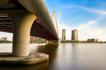 Landscape of Ba Son bridge spanning the Saigon river at sunset. Ho Chi Minh City, Vietnam.