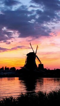 Windmills at famous tourist site Zaanse Schans in Holland on sunset with dramatic sky. Zaandam, Netherlands