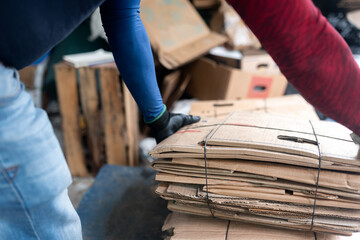 Hispanic Man's Hands Measuring Cardboard in Recycling Facility. Close Up