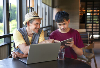 mature man on vacation takes a coffee break with his son in cafe on the mountain,destination in...