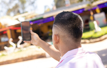 man taking a photo on a sunny day