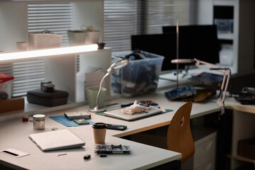 Background image of workstation with tools and electronics in computer repair shop, copy space