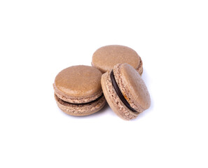 A group of dark chocolate macarons isolated over white background