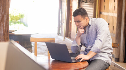 man working on a computer while smiling