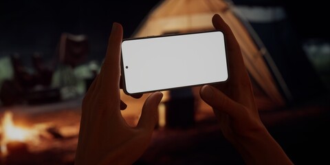 CU Caucasian male using his phone near campsite in the evening, screen mockup