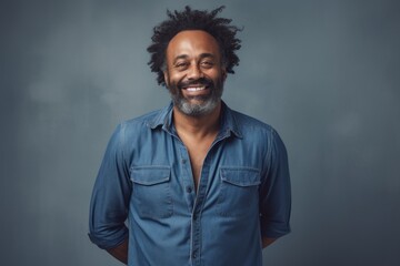 Portrait of a glad afro-american man in his 40s sporting a versatile denim shirt against a bare monochromatic room. AI Generation