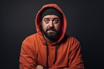 Fototapeta premium Portrait of a glad man in his 30s sporting a comfortable hoodie against a plain cyclorama studio wall. AI Generation