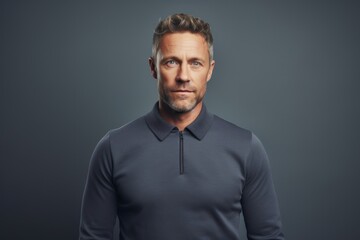 Obraz premium Portrait of a content man in his 40s donning a classy polo shirt against a plain cyclorama studio wall. AI Generation