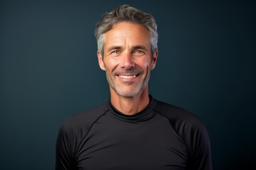Fototapeta premium Portrait of a joyful man in his 50s sporting a breathable mesh jersey against a plain cyclorama studio wall. AI Generation