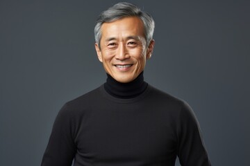 Fototapeta premium Portrait of a happy asian man in his 50s wearing a classic turtleneck sweater against a crisp minimalistic living room. AI Generation