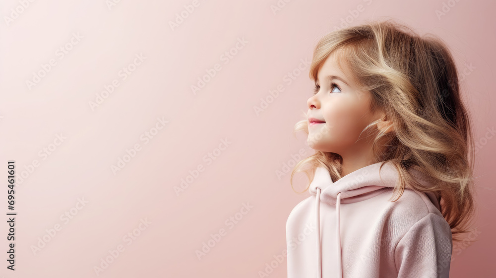 Wall mural portrait of a beautiful cute little girl in profile, studio, pastel colors, stylish casual clothes, smiling child, kid, preschooler, emotional portrait, facial expression, background, space for text - Wall murals