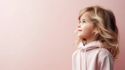 Foto op Canvas portrait of a beautiful cute little girl in profile, studio, pastel colors, stylish casual clothes, smiling child, kid, preschooler, emotional portrait, facial expression, background, space for text © Julia Zarubina