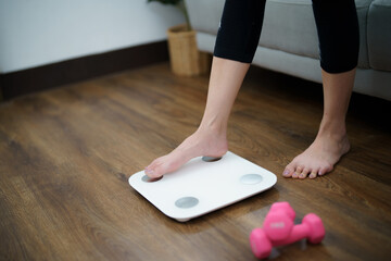 Fat diet and scale feet standing on electronic scales for weight control. Measurement instrument in kilogram for a diet control - obrazy, fototapety, plakaty
