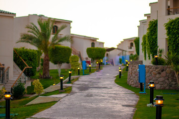 Walkway among bungalows with lanterns