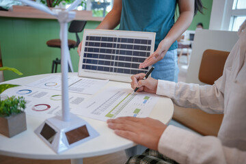 Solar panels green energy Business people working in green eco friendly office business meeting creative ideas for business eco friendly professional teaching corporate people sustainable electricity