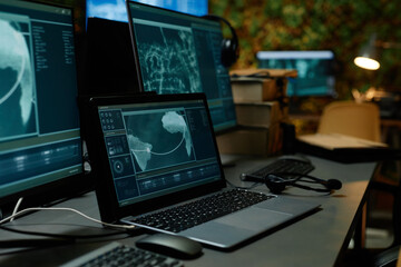 Laptop with secret data on screen standing on workplace of military officer or operator against...