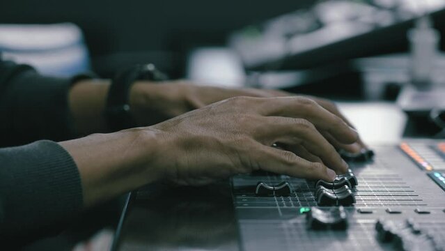 Dj controller, knobs and faders,Sound production concept. Sound mixing panel is being regulated by a producer, sound studio equipment