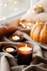warm cozy window arrangement, winter or autumn concept, candles throw lights