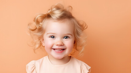 Cute smiling baby girl portrait close up peach fuzz colors