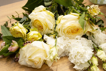 Floristry. Flowers. Yellow and white bouquet of roses, soft focus.