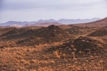 Red desert Boguty Mountains with red spines in Almaty region, Kazakhstan On the Sunset