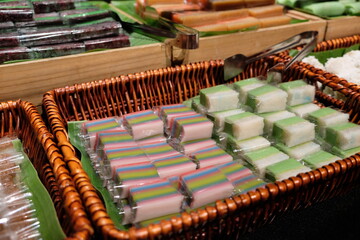 Varity Malaysian south east Asian nyonya kuih sweet desert sago tilam pulut terkan inti koci bongkus koo lapis dodol onde onde on green banana leaf wooden plate
