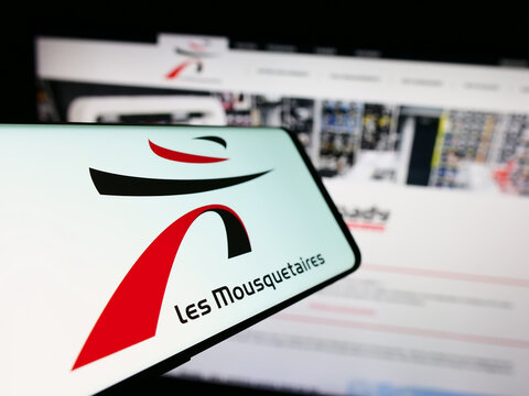 Stuttgart, Germany - 12-08-2023: Smartphone with logo of French company ITM Entreprises S.A. (Les Mousquetaires) in front of website. Focus on center-left of phone display.