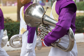 Students carry mellophones in the school orchestra procession It is a medium-pitched brass...