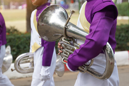 Students carry mellophones in the school orchestra procession It is a medium-pitched brass instrument used in marching bands and is used to play the French horn section in bands and orchestras.