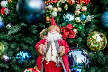 Santa in group or standing alone in front of beautiful christmas tree decorative with chritmas toys, balls and gifts box.