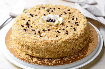 Delicious Napoleon Cake, Delicate Handmade Dessert with Custard and Puff Pastry Layers on Bright Background