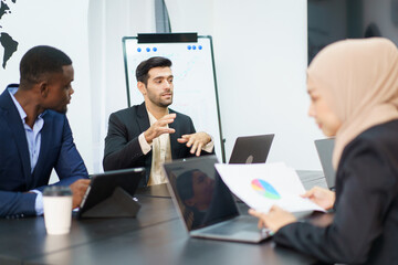 Businessman presenting a business and sales report to team.
