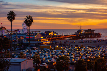 The beachfront parking lot in Santa Monica, california during sunset. Picture taken from the bluffs with the santa monica pier in the background.