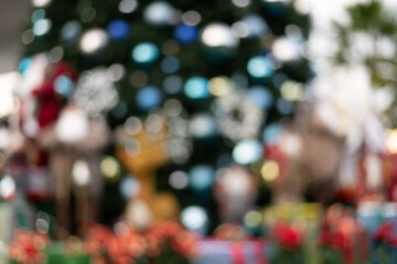 Fototapeta premium Defocus and blur image of Santa in group in front of beautiful christmas tree decorative with chritmas toys, balls and gifts box.