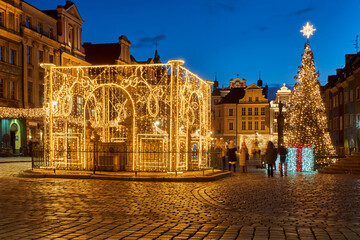 Fototapeta na wymiar Christmas decorations in the evening at the Old Market Square in Poznan