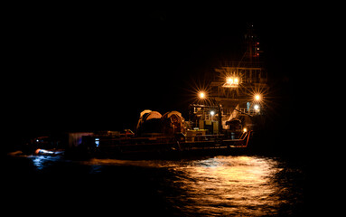 The ship standing on an anchor at night.
