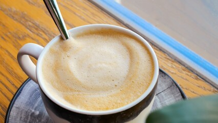 Hand stirs coffee foam spoon, health-conscious routine. mindful preparation coffee, health aspect...