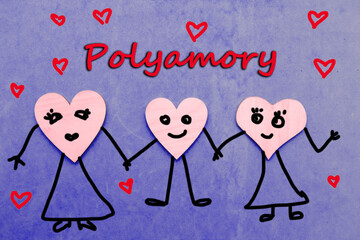 Three wooden hearts with draw faces hold hands - polyamory concept