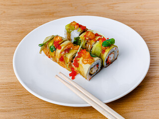 Tasty and beautiful sushi plate from the best sushi restaurant, the concept. Sushi rolls with rice and fish, soy sauce on a wooden table background. Overhead shot of Japanese seafood sushi set. 