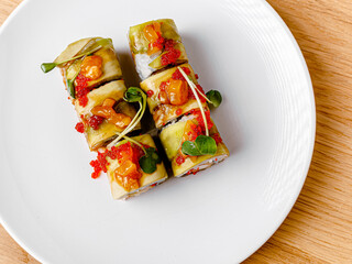 Tasty and beautiful sushi plate from the best sushi restaurant, the concept. Sushi rolls with rice and fish, soy sauce on a wooden table background. Overhead shot of Japanese seafood sushi set. 