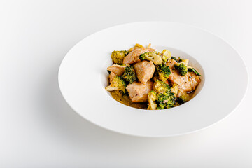 Vindaloo with spinach in white bowl isolated on white background. Portuguese Influenced Indian dish made by cooking chicken in vindaloo spice paste and broccolli.